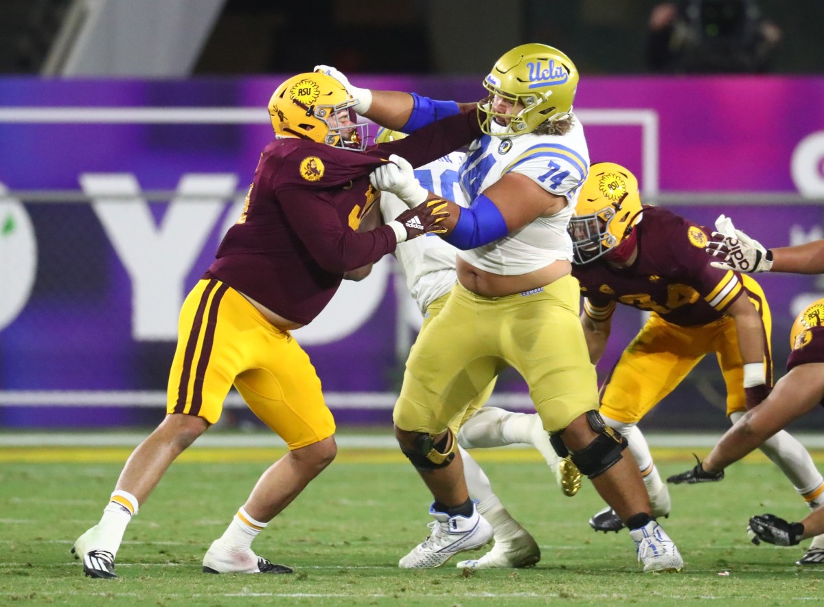 UCLA offensive lineman Sean Rhyan blocks against Arizona State